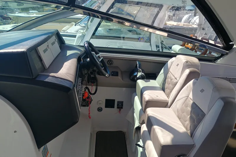 350-004 Brokerage Joe Yacht Photos Pics 2019 Four Winns H350 OB boat cockpit with dual seats and steering wheel.