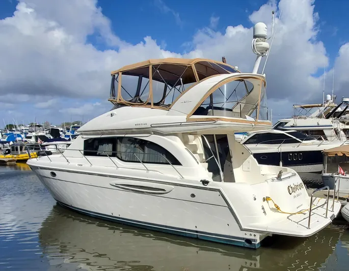 Chelarious Yacht Photos Pics 2005 Meridian 411 Sedan yacht docked at marina under blue sky.