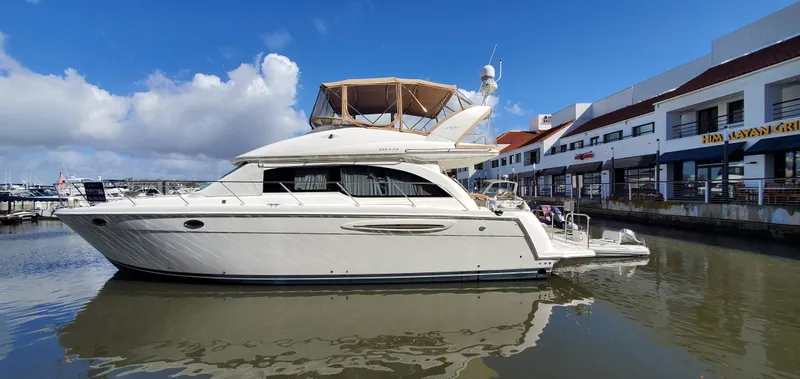 Chelarious Yacht Photos Pics 2005 Meridian 411 Sedan yacht docked at marina, clear sky, calm water.