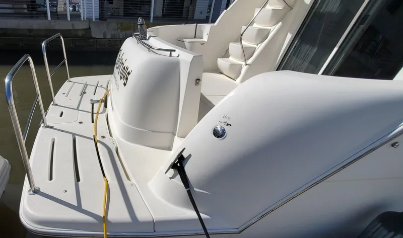 Chelarious Yacht Photos Pics 2005 Meridian 411 Sedan yacht with rear deck and stairs, docked at marina.
