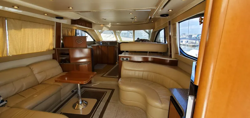 Chelarious Yacht Photos Pics Luxurious interior of a 2005 Meridian 411 Sedan yacht with leather seating and wood accents.