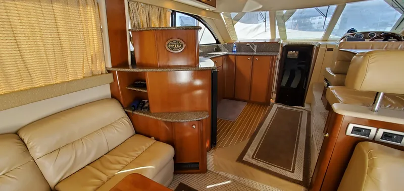 Chelarious Yacht Photos Pics Luxurious interior of 2005 Meridian 411 Sedan yacht with leather seating and wood finishes.