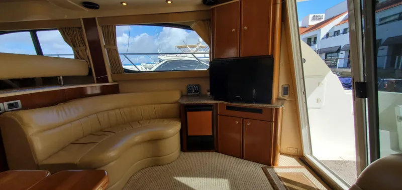 Chelarious Yacht Photos Pics Luxurious interior of 2005 Meridian 411 Sedan yacht with leather seating and TV.