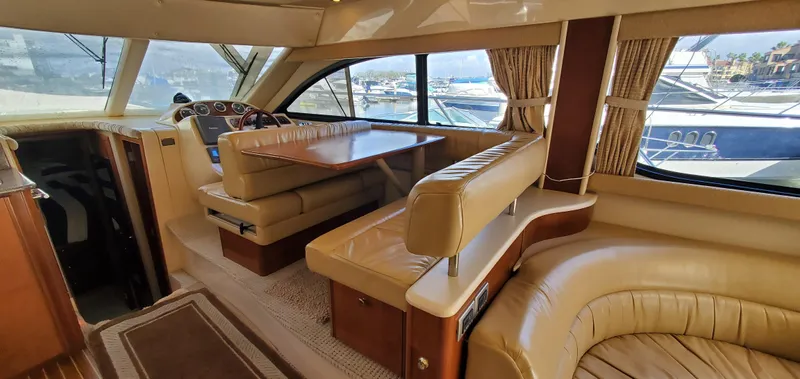 Chelarious Yacht Photos Pics Luxurious interior of a 2005 Meridian 411 Sedan yacht with elegant seating and dining area.