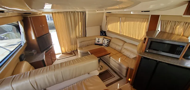 Chelarious Yacht Photos Pics Luxurious interior of a 2005 Meridian 411 Sedan yacht with leather seating and modern amenities.