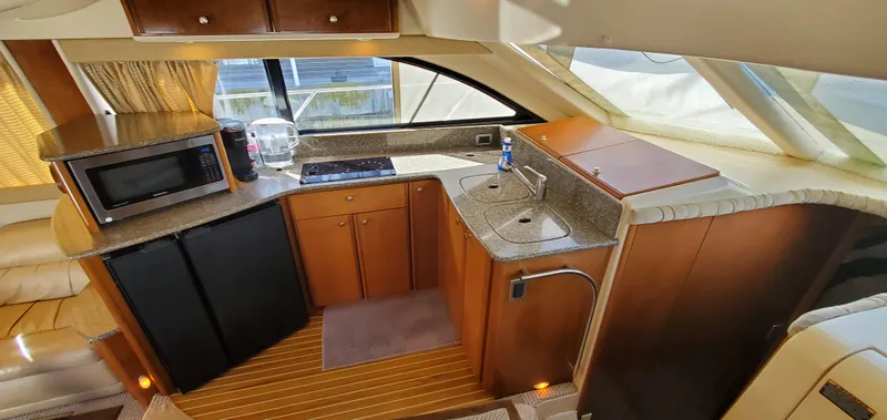Chelarious Yacht Photos Pics 2005 Meridian 411 Sedan yacht kitchen with microwave, fridge, and sink.