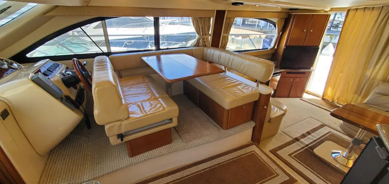 Chelarious Yacht Photos Pics Luxurious interior of a 2005 Meridian 411 Sedan yacht with plush seating and elegant decor.