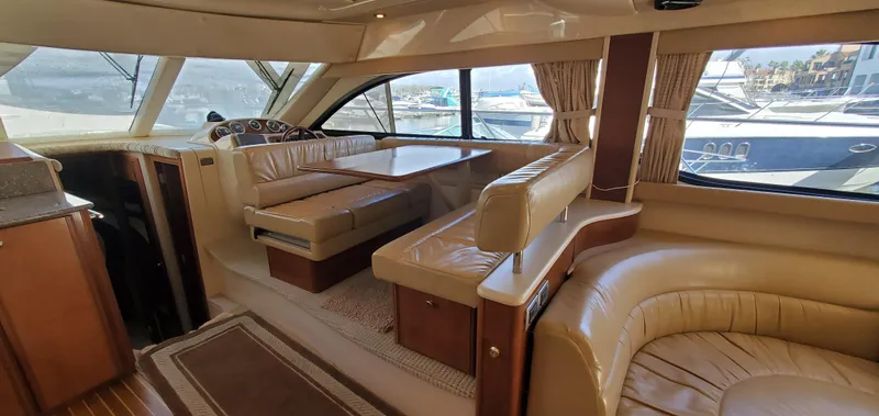 Chelarious Yacht Photos Pics Interior of a 2005 Meridian 411 Sedan yacht with luxurious seating and large windows.