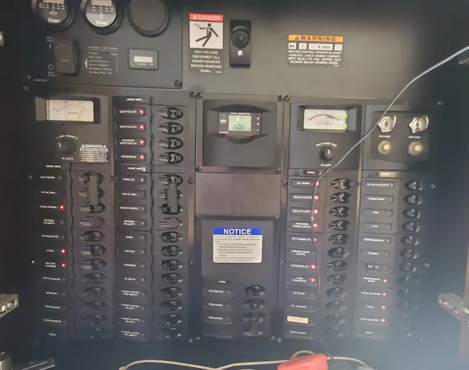 Chelarious Yacht Photos Pics Electrical control panel of a 2005 Meridian 411 Sedan boat with various switches and gauges.