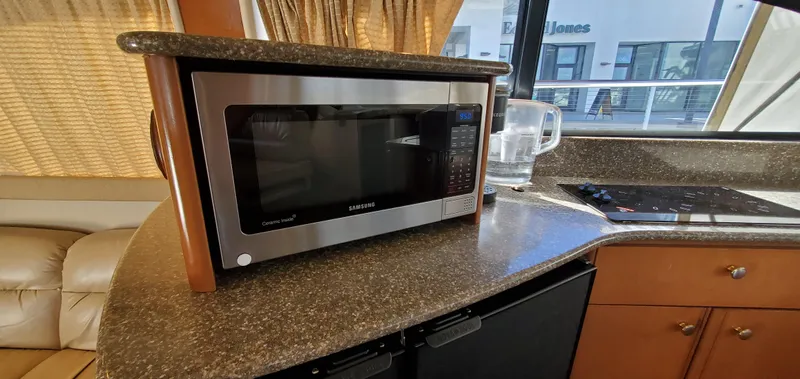 Chelarious Yacht Photos Pics Microwave in 2005 Meridian 411 Sedan yacht kitchen with countertop and cabinets.
