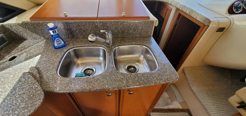 Chelarious Yacht Photos Pics Kitchen sink area in a 2005 Meridian 411 Sedan yacht with granite countertop.