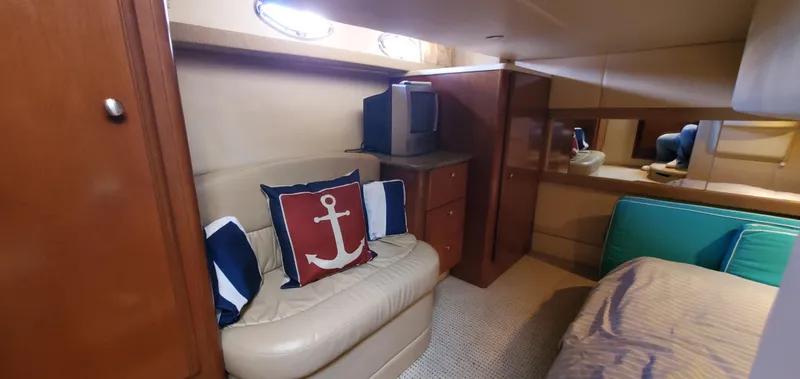 Chelarious Yacht Photos Pics Interior of 2005 Meridian 411 Sedan with cozy seating and nautical-themed decor.