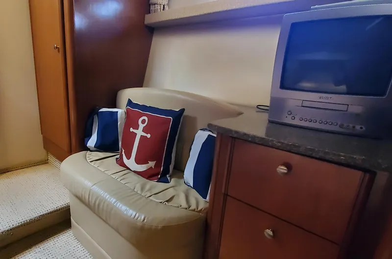 Chelarious Yacht Photos Pics Interior of 2005 Meridian 411 Sedan with anchor-themed decor and vintage TV.