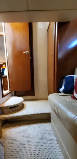 Chelarious Yacht Photos Pics Interior of 2005 Meridian 411 Sedan yacht with wooden doors and carpeted flooring.