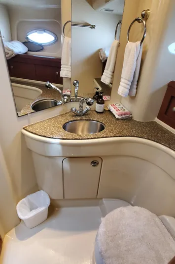 Chelarious Yacht Photos Pics 2005 Meridian 411 Sedan bathroom with sink, mirror, and towels.