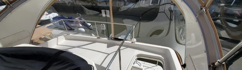 Chelarious Yacht Photos Pics 2005 Meridian 411 Sedan yacht interior with seating and helm, featuring sleek design elements.