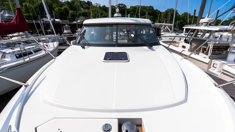  Yacht Photos Pics 2018 Jeanneau NC11 yacht docked at marina, showcasing sleek design and spacious deck.