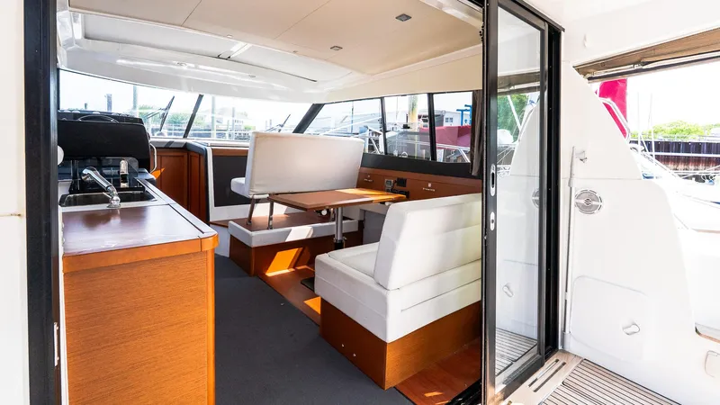  Yacht Photos Pics Interior of 2018 Jeanneau NC11 yacht with modern seating and dining area.