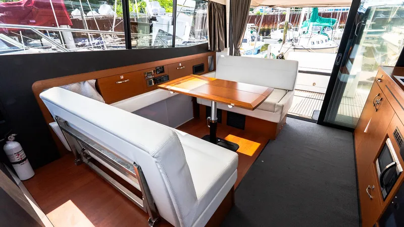  Yacht Photos Pics Interior of 2018 Jeanneau NC11 yacht with modern seating and dining area.