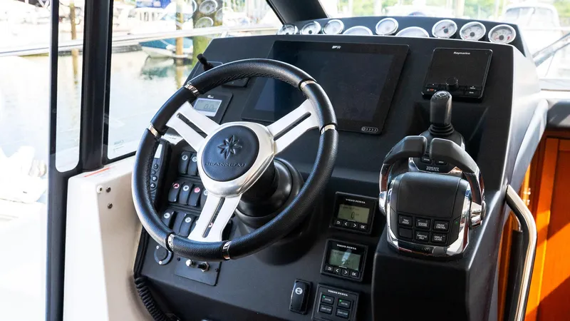  Yacht Photos Pics 2018 Jeanneau NC11 boat dashboard with steering wheel and controls.