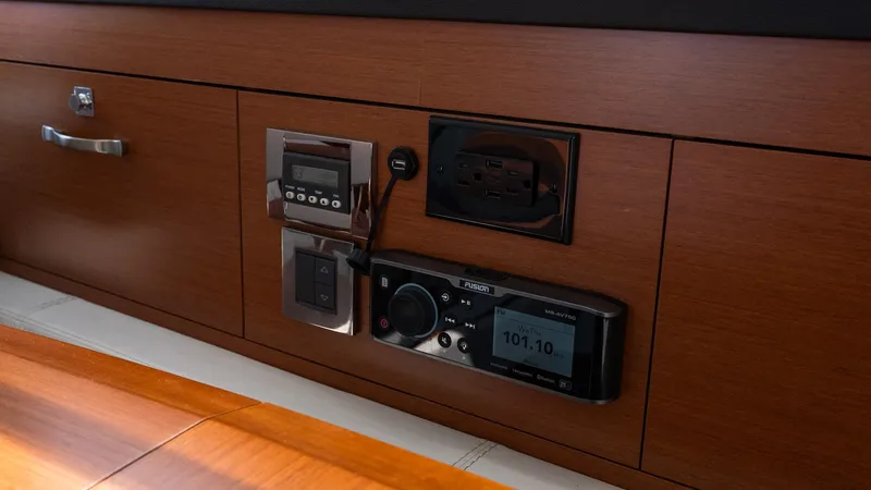  Yacht Photos Pics Control panel on 2018 Jeanneau NC11 yacht with wood finish and electronic displays.