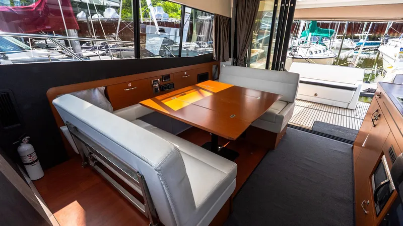  Yacht Photos Pics Interior of 2018 Jeanneau NC11 yacht with dining area and large windows.