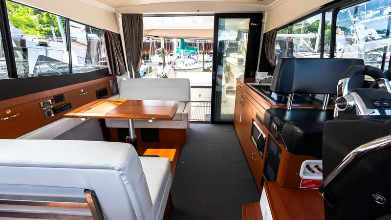  Yacht Photos Pics Interior of 2018 Jeanneau NC11 yacht with modern seating and navigation area.