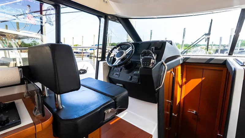  Yacht Photos Pics 2018 Jeanneau NC11 boat interior with steering wheel and control panel.