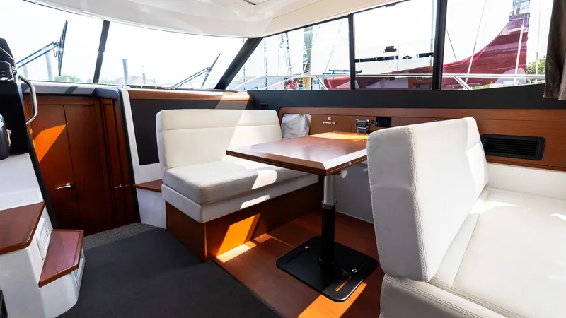  Yacht Photos Pics Interior of 2018 Jeanneau NC11 yacht with modern seating and dining area.