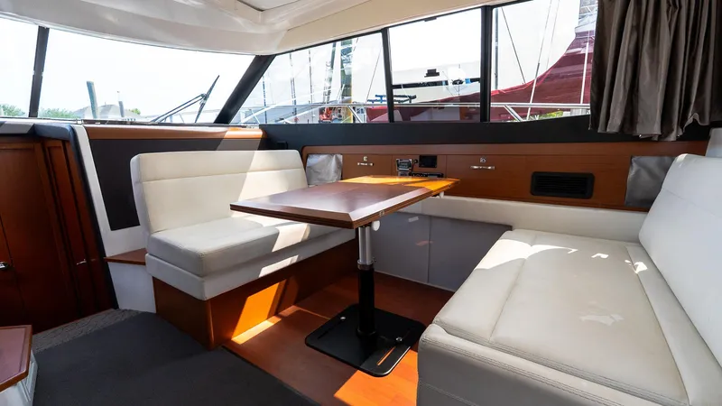  Yacht Photos Pics Interior of 2018 Jeanneau NC11 yacht with elegant seating and dining area.