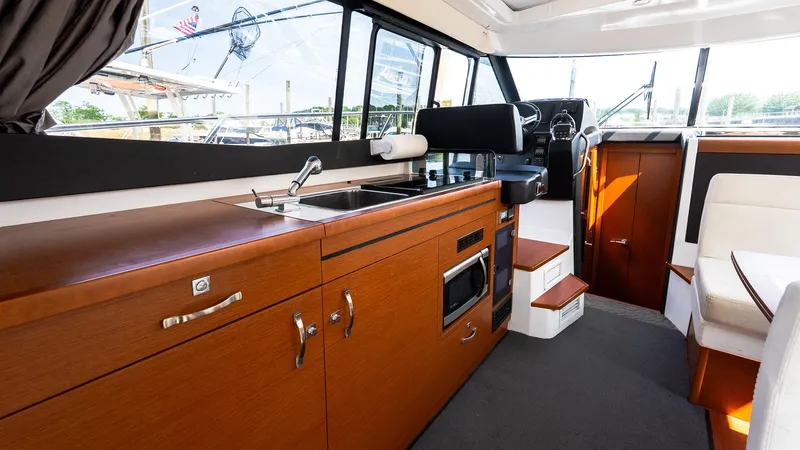  Yacht Photos Pics Interior of 2018 Jeanneau NC11 yacht with modern kitchen and helm station.