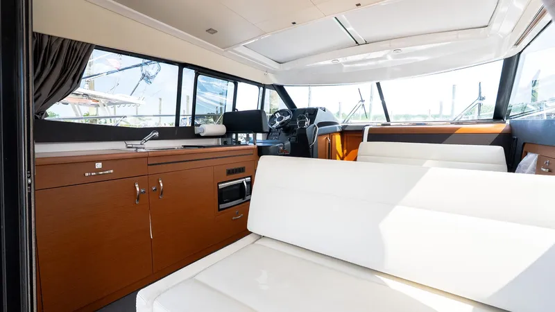  Yacht Photos Pics Interior of 2018 Jeanneau NC11 yacht with modern seating and kitchen area.