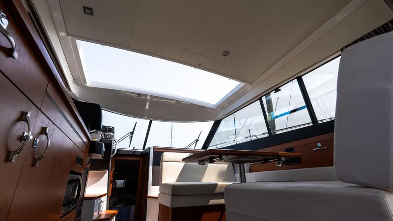  Yacht Photos Pics Interior of 2018 Jeanneau NC11 yacht, featuring modern seating and panoramic windows.