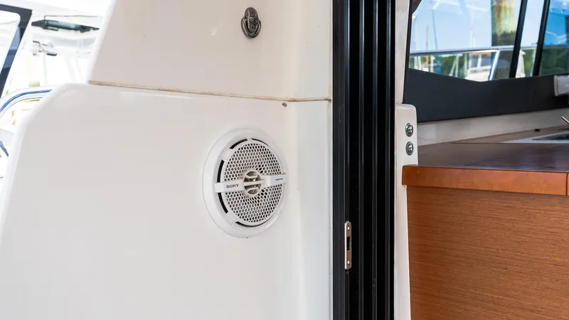  Yacht Photos Pics 2018 Jeanneau NC11 boat interior with speaker and wooden cabinetry.