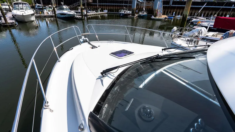  Yacht Photos Pics 2018 Jeanneau NC11 boat docked in a marina, showcasing sleek design and spacious deck.