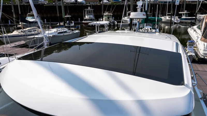  Yacht Photos Pics 2018 Jeanneau NC11 yacht docked at marina, showcasing sleek design and sunroof.