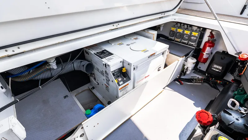  Yacht Photos Pics Engine compartment of 2018 Jeanneau NC11 boat with generator and fire extinguisher.