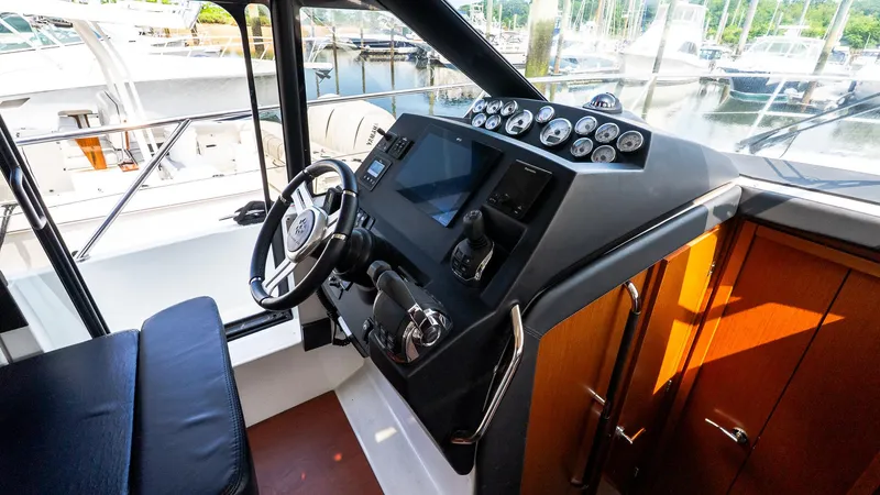  Yacht Photos Pics 2018 Jeanneau NC11 helm with modern controls and sleek design.