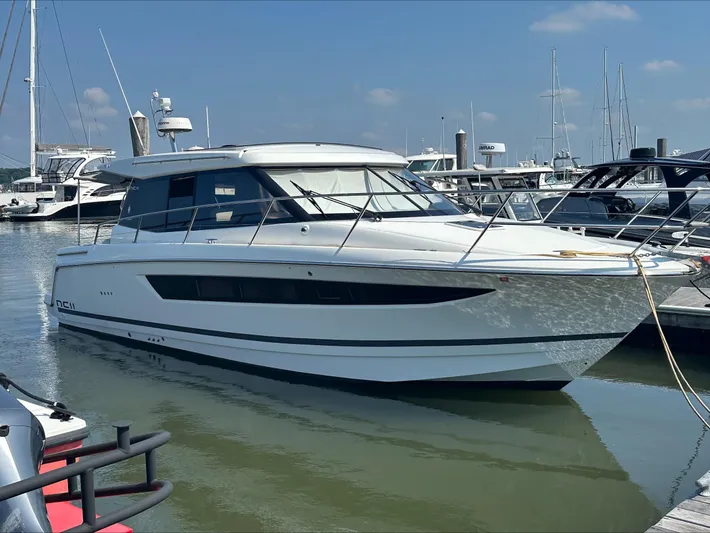  Yacht Photos Pics 2018 Jeanneau NC11 yacht docked at marina under clear blue sky.