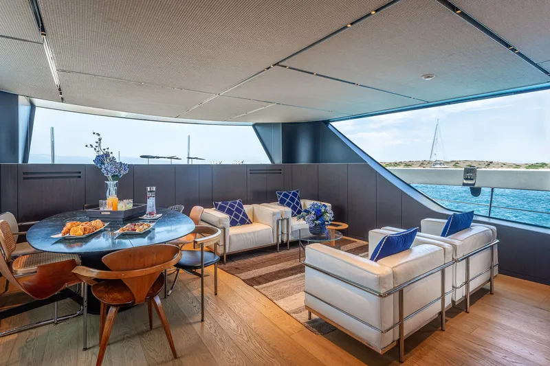 Just Marie 3 Yacht Photos Pics Luxurious interior of 2021 Sanlorenzo SX112 yacht with elegant seating and dining area.