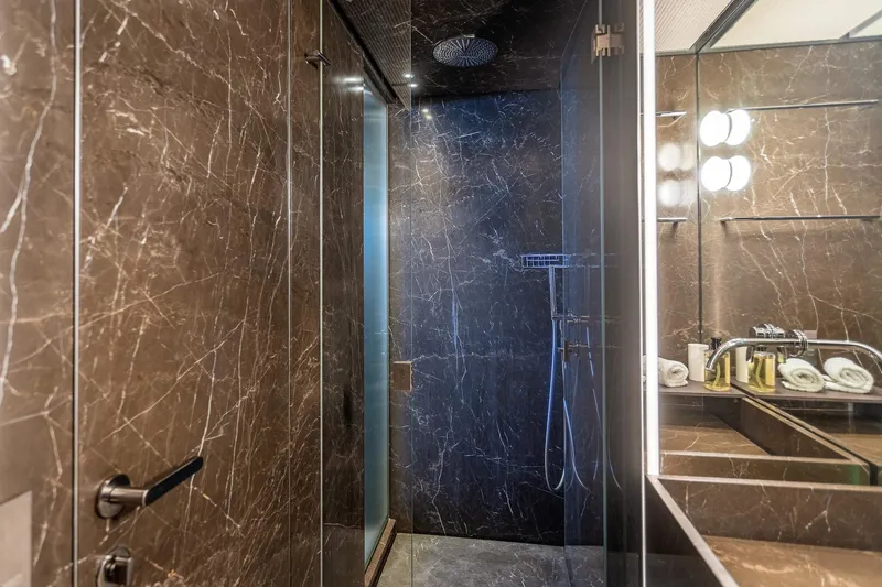 Just Marie 3 Yacht Photos Pics Luxurious marble bathroom in 2021 Sanlorenzo SX112 yacht, featuring modern fixtures and elegant design.