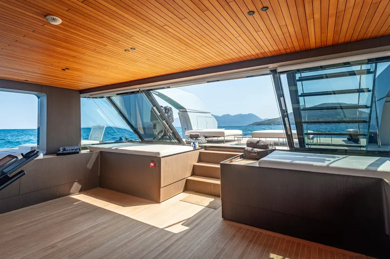 Just Marie 3 Yacht Photos Pics Luxurious interior of 2021 Sanlorenzo SX112 yacht with ocean view and wooden ceiling.