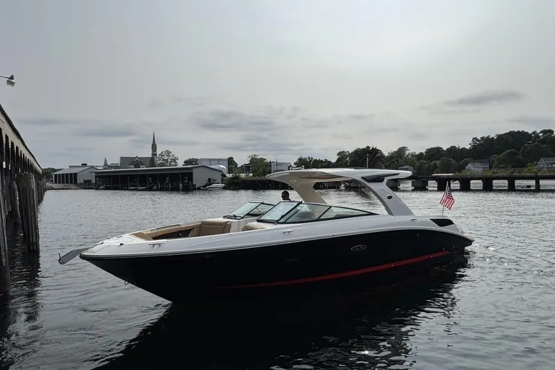  Yacht Photos Pics 2024 Sea Ray SLX 350 boat docked near a pier, with scenic waterfront background.