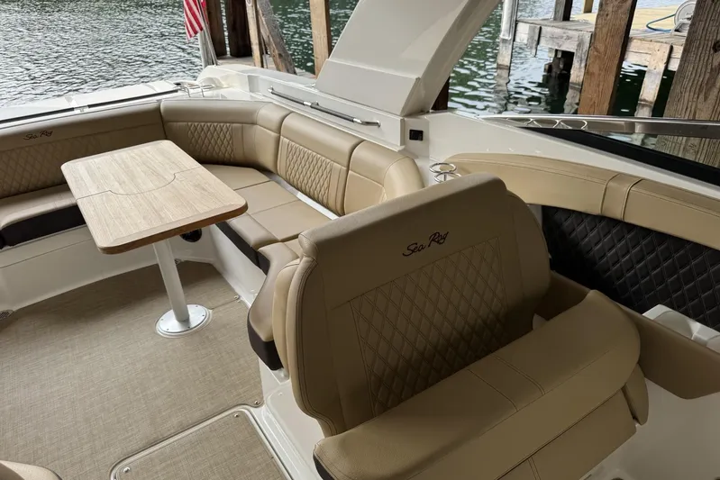  Yacht Photos Pics Luxurious interior of 2024 Sea Ray SLX 350 boat with elegant seating and table.
