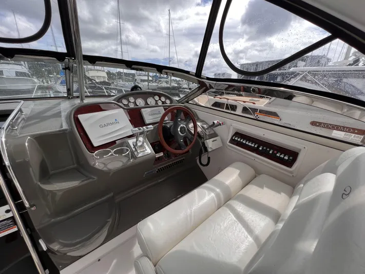 Sharon Ann Yacht Photos Pics 2007 Regal Commodore 3760 IB boat cockpit with steering wheel and navigation equipment.