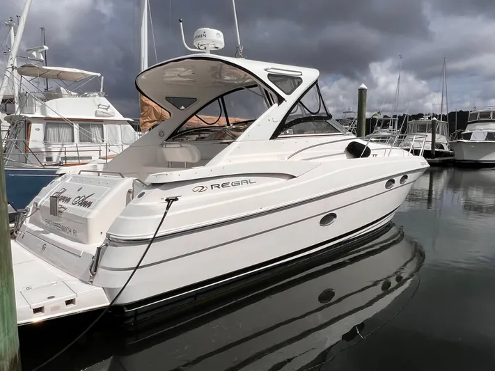 Sharon Ann Yacht Photos Pics 2007 Regal Commodore 3760 IB yacht docked in a marina under cloudy skies.
