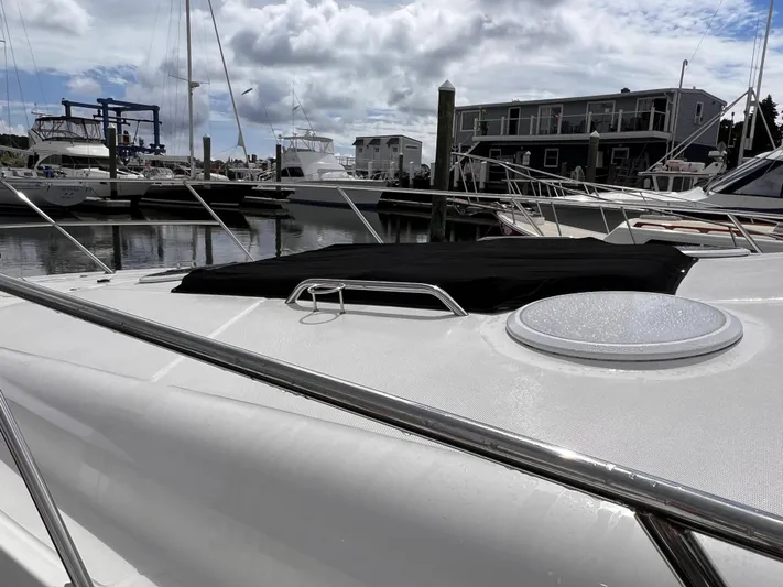 Sharon Ann Yacht Photos Pics 2007 Regal Commodore 3760 IB yacht docked at marina under cloudy sky.