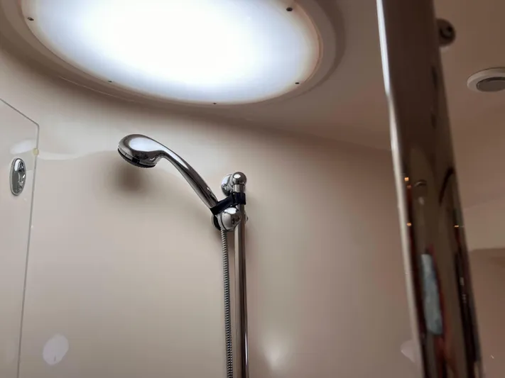 Sharon Ann Yacht Photos Pics Shower area inside 2007 Regal Commodore 3760 IB yacht, featuring a modern showerhead.