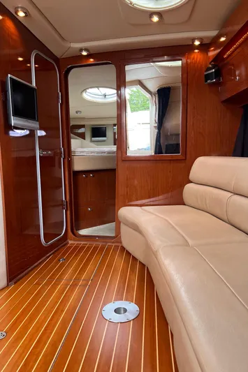 Sharon Ann Yacht Photos Pics Luxurious interior of 2007 Regal Commodore 3760 IB yacht with leather seating and wood flooring.