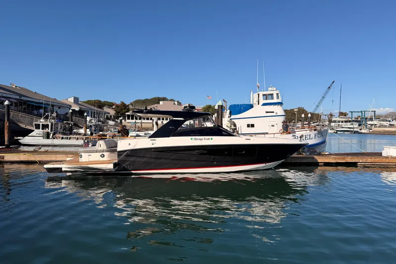  Yacht Photos Pics 2021 Sea Ray SLX 400 yacht docked at a marina under clear blue skies.